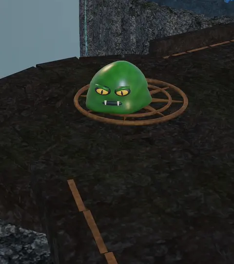 A green slime on a dark stone ledge with cloud below
