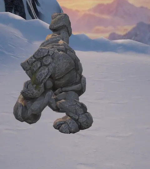 A creature made of stacked stones on snow, with a sunset behind